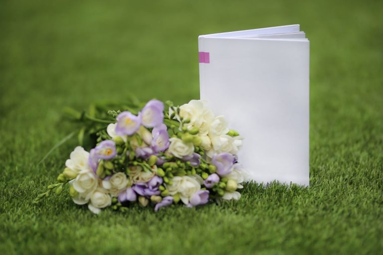 upright book and flowers on a lawn